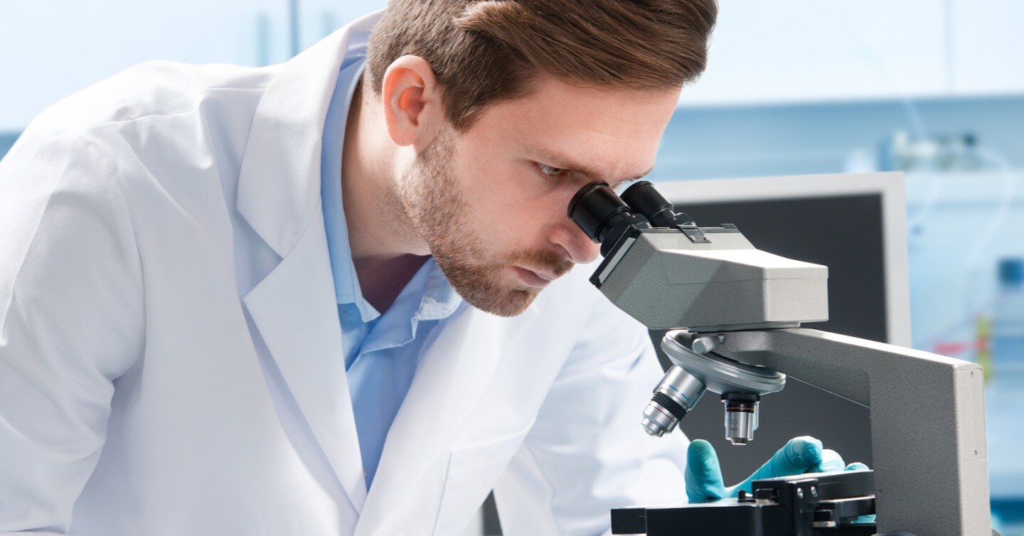 scientist looking in microscope