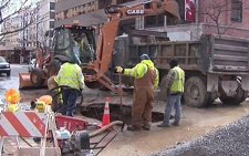 Workers evaluating surge suppression in water distribution system
